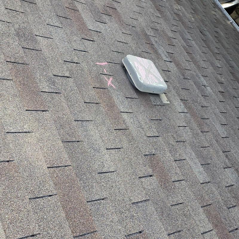 Roof shingles with vent and pink chalk markings
