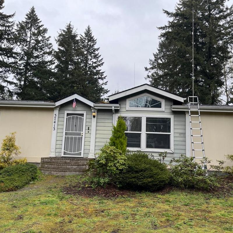 Roof with extension ladder for cleaning in Hayden, ID