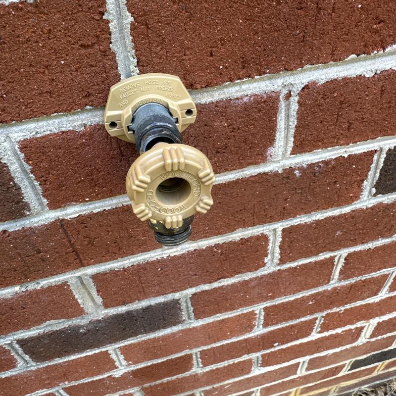 Frost proof hose bib on red brick wall