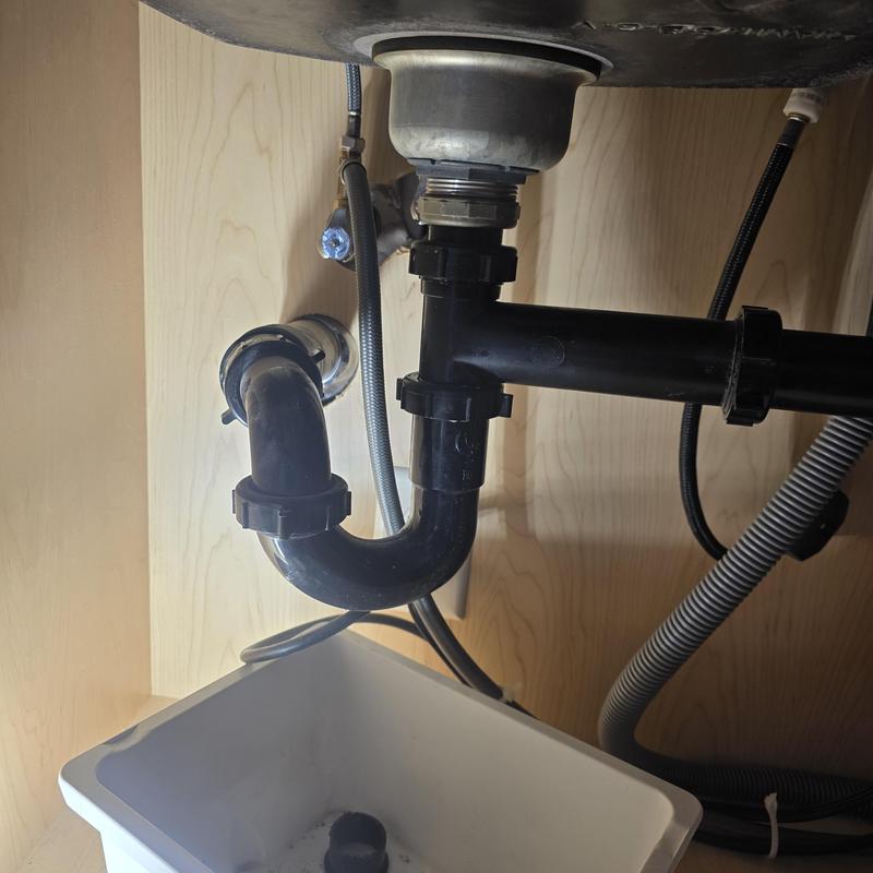 Kitchen sink drain pipe with trap under cabinet