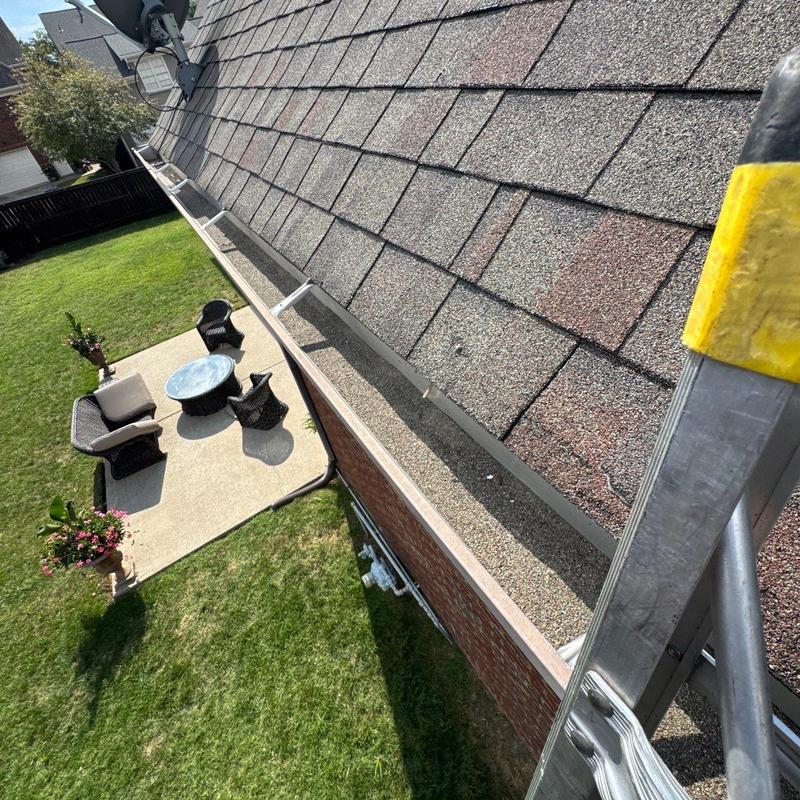 Asphalt shingle roof with hail damage and gutter system