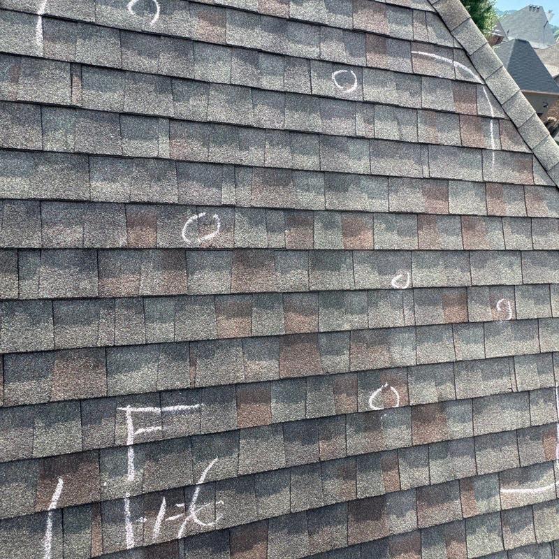 Asphalt shingle roof with hail damage markings