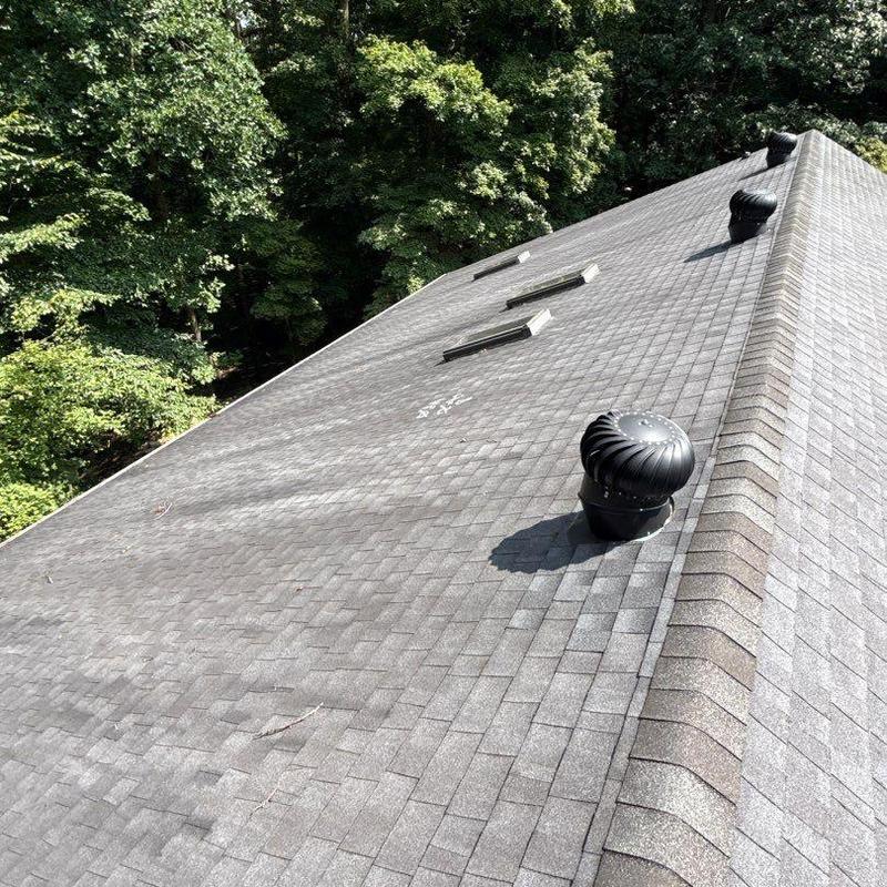 Roof shingles with hail damage and ventilation turbines