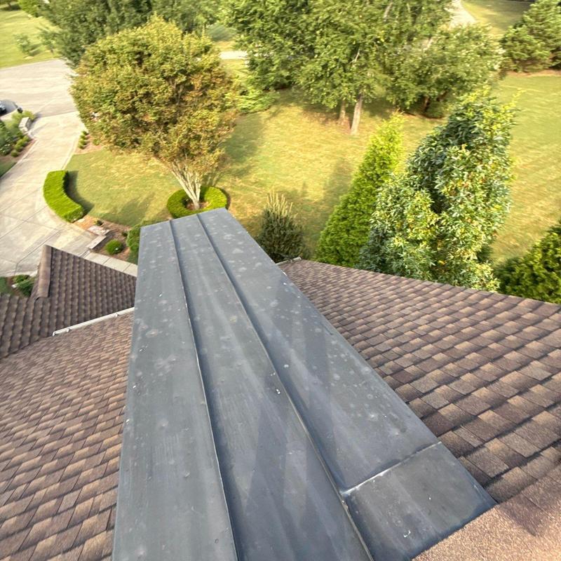 Roof flashing with hail damage on asphalt shingles