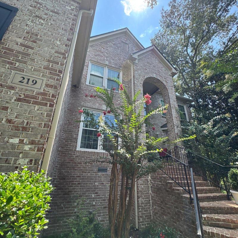 Brick exterior with entry stairs and railing at home