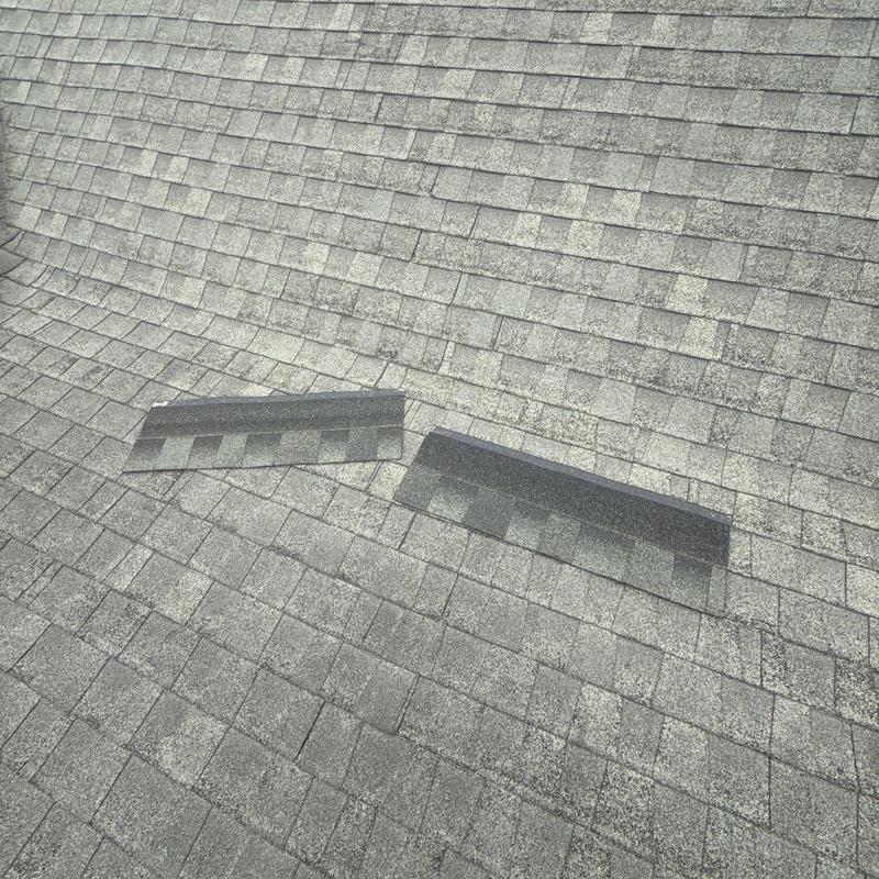 Roof shingles with hail damage on asphalt roof