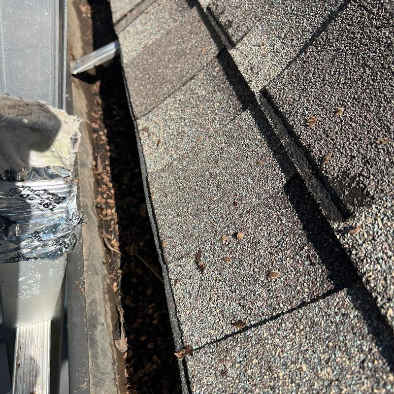 Roof shingles with hail impact damage close-up view