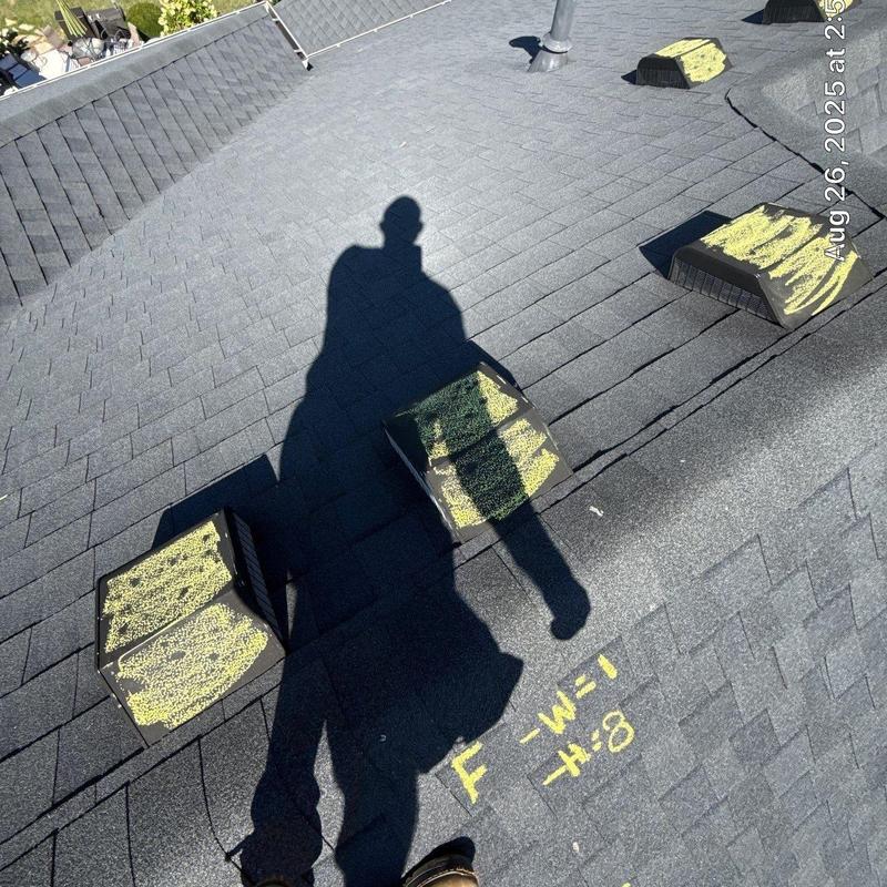 Roof shingles with marked hail damage on vents