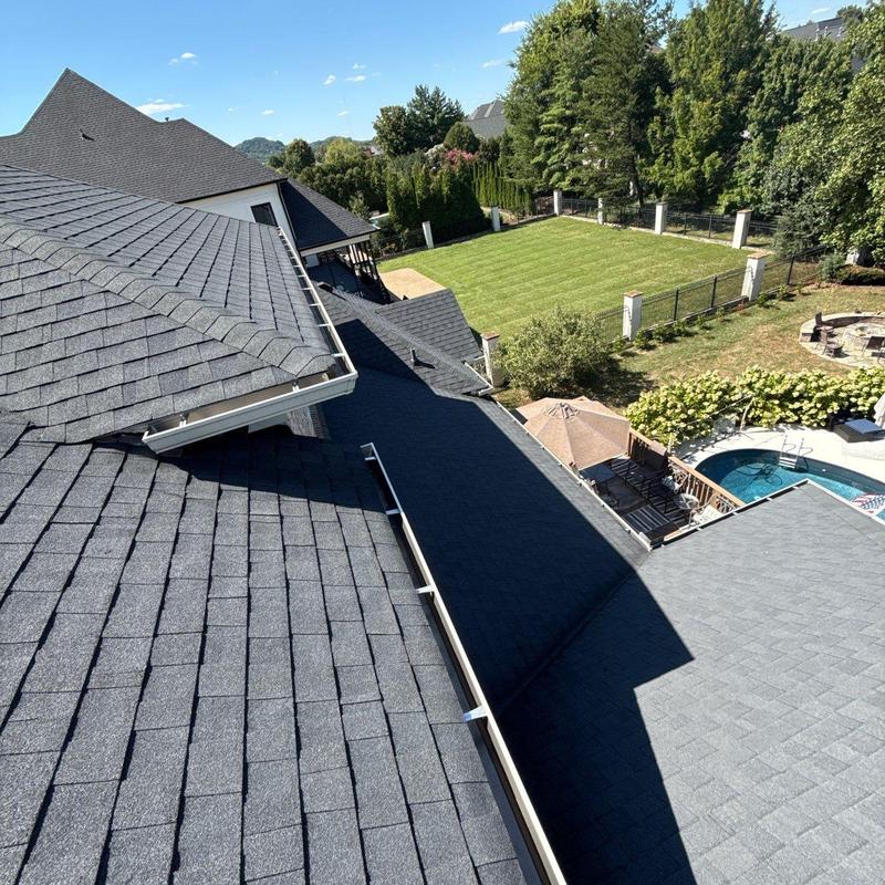 Asphalt shingle roof with gutters and backyard view