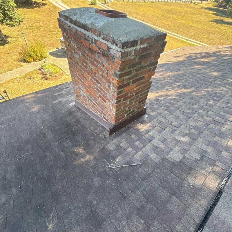 Roof shingles and chimney flashing on residential roof