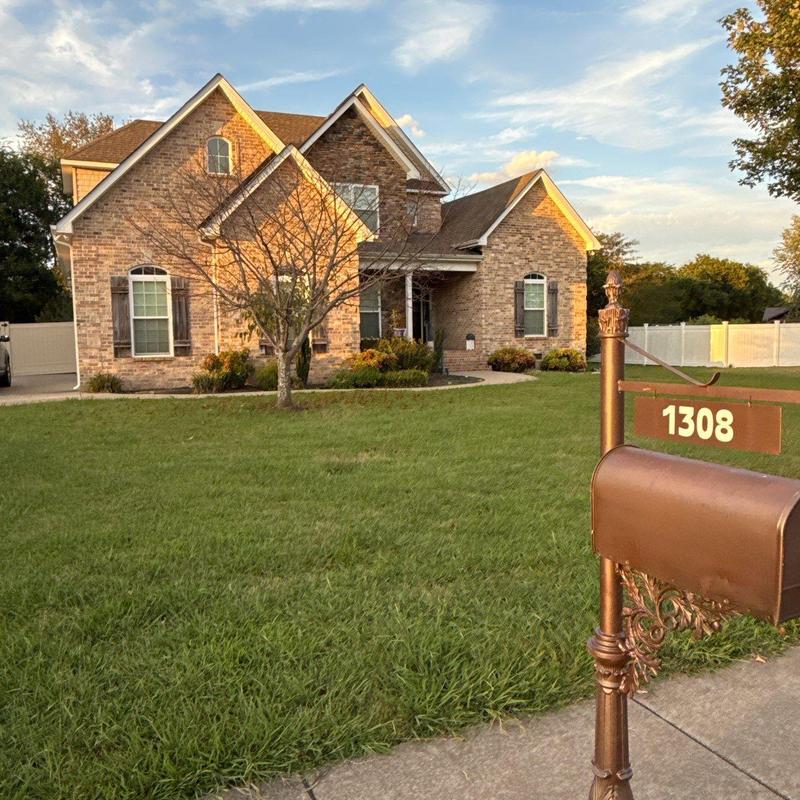 Brick house exterior and front yard with mailbox
