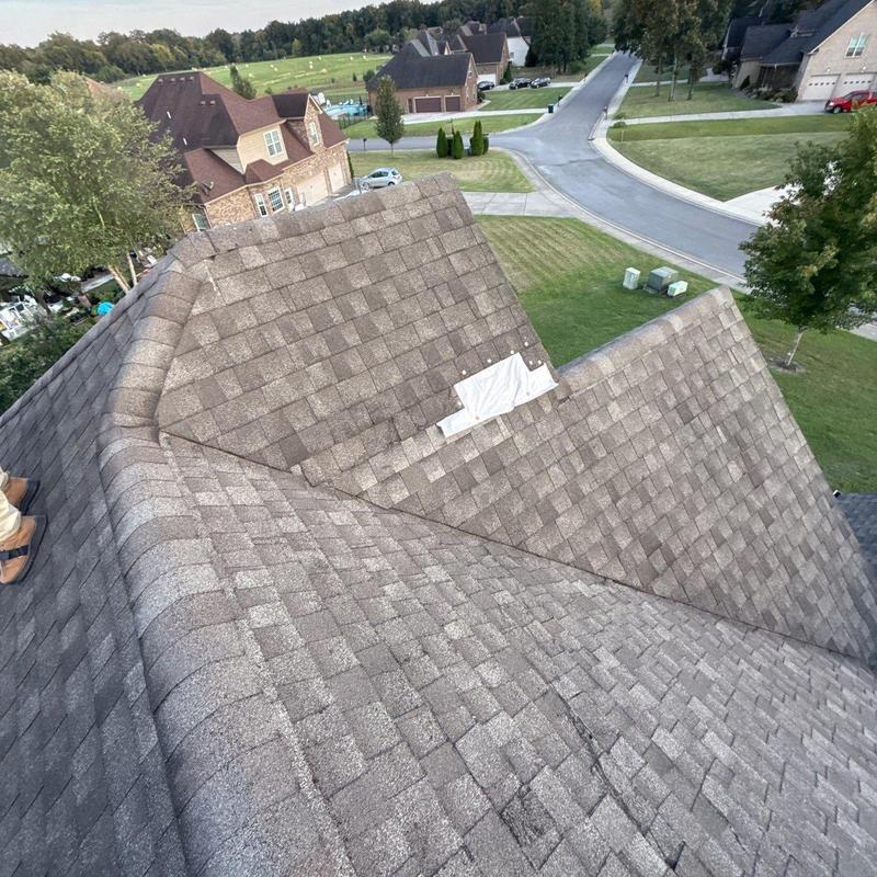 Architectural shingle roof with hail damage and patch
