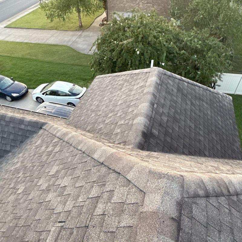 Asphalt shingle roof ridge with hail damage inspection