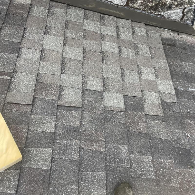 Asphalt roof shingles with step flashing and sealant Asphalt roof shingles with step flashing and sealant