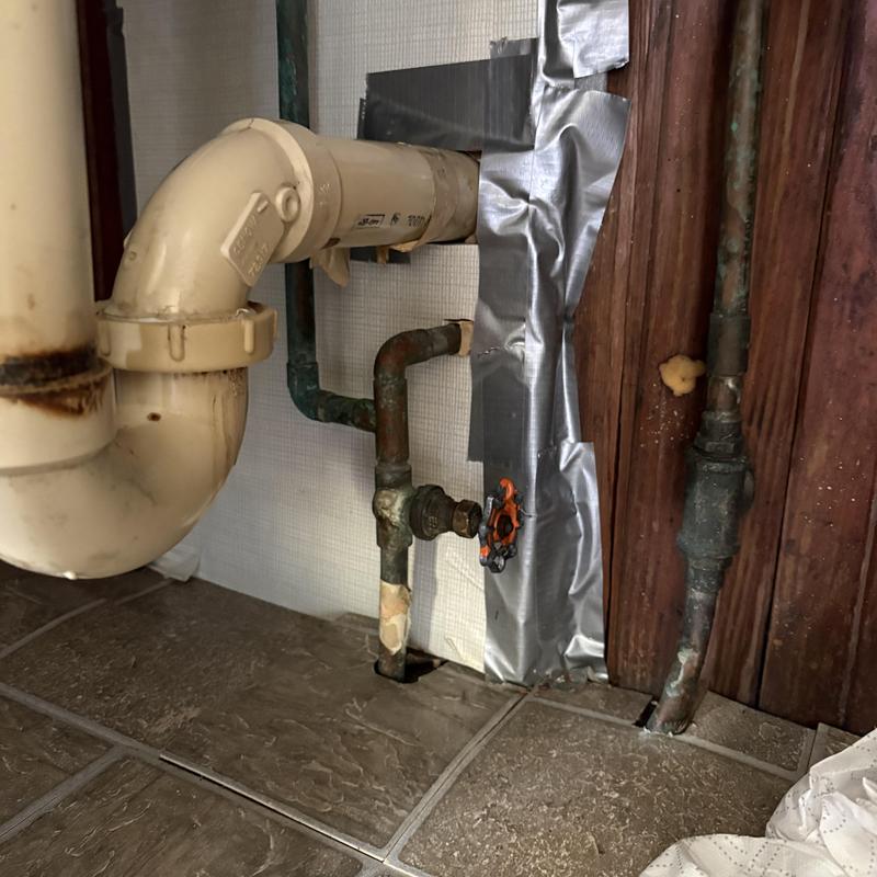 Gate valve and copper water pipes under sink