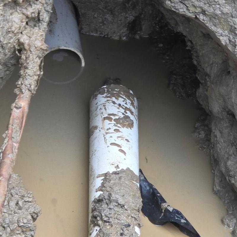 Sewer pipe excavation with cored hole for pitch adjustment