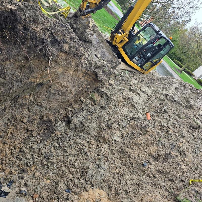 Sewer line excavation for pitch adjustment with excavator