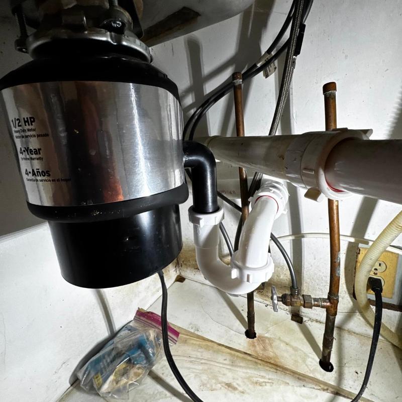 Garbage disposal and PVC drain plumbing under sink