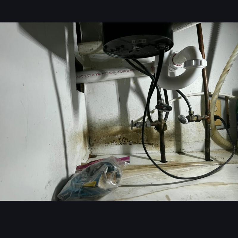PVC sink drain with tubular P trap inside cabinet