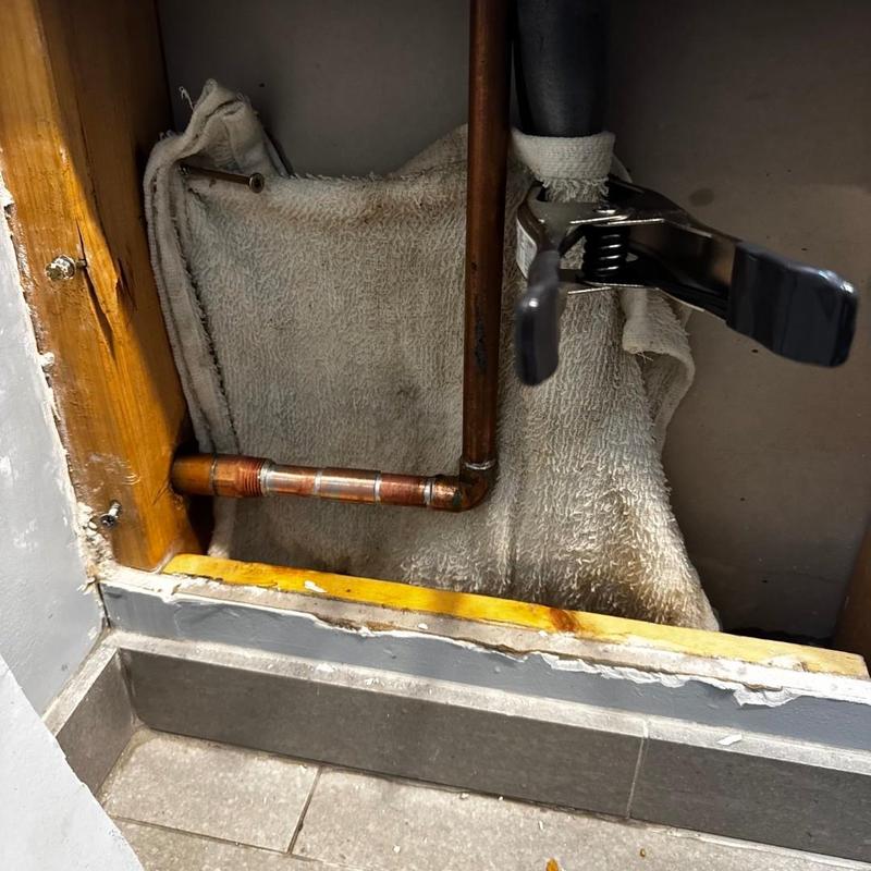 Hose bib pipe with clamp and towel in wall cavity