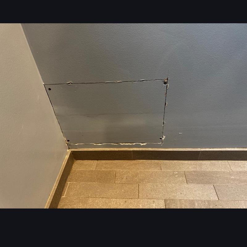Drywall access panel cut for plumbing leak repair