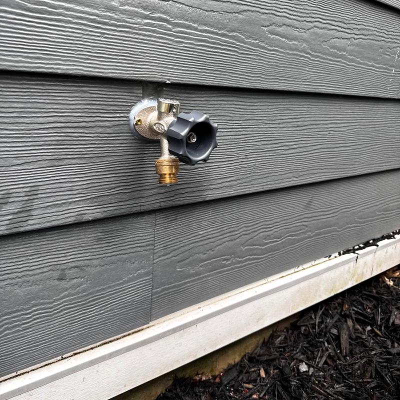 10 frost free hose bib on gray siding exterior