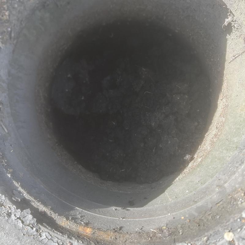 Storm water basin opening with debris buildup