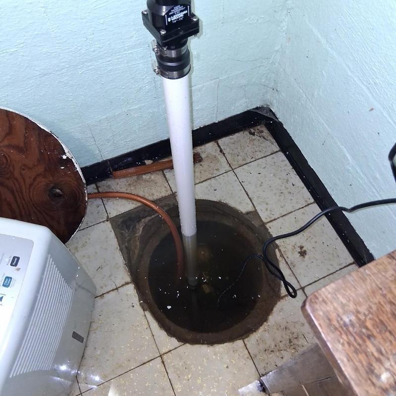 Sump pump system installed in tiled basement floor