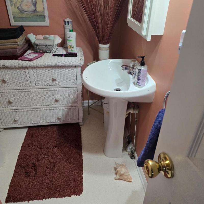 Pedestal sink installation in small bathroom corner