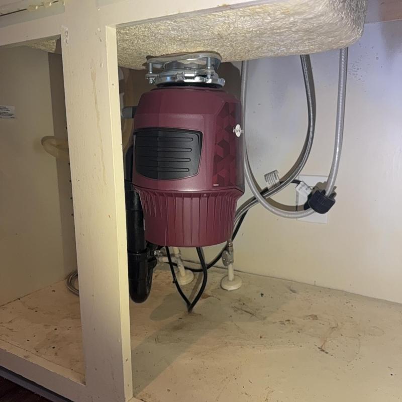 Garbage disposal unit installed under kitchen sink
