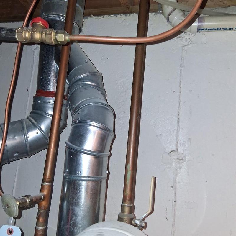 Copper gas lines and vent pipes in basement wall