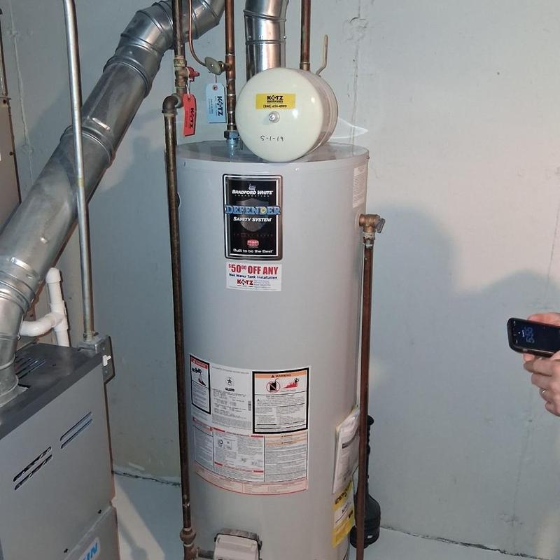 Water heater with vent pipes in basement