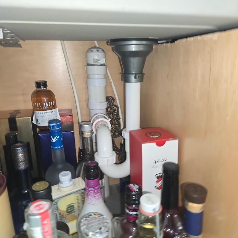Washing machine drain pipe and cabinet plumbing setup