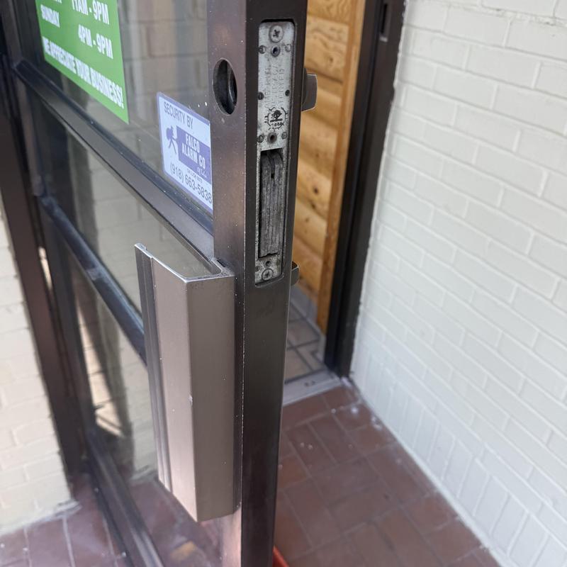 Door lock latch on commercial glass door installation