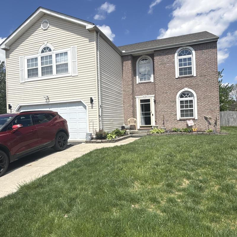 Vinyl siding and brick exterior on two-story house