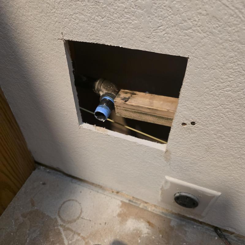 Gas line pipe protruding through drywall cavity