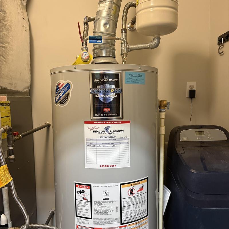 Water heater with safety system and plumbing service tag