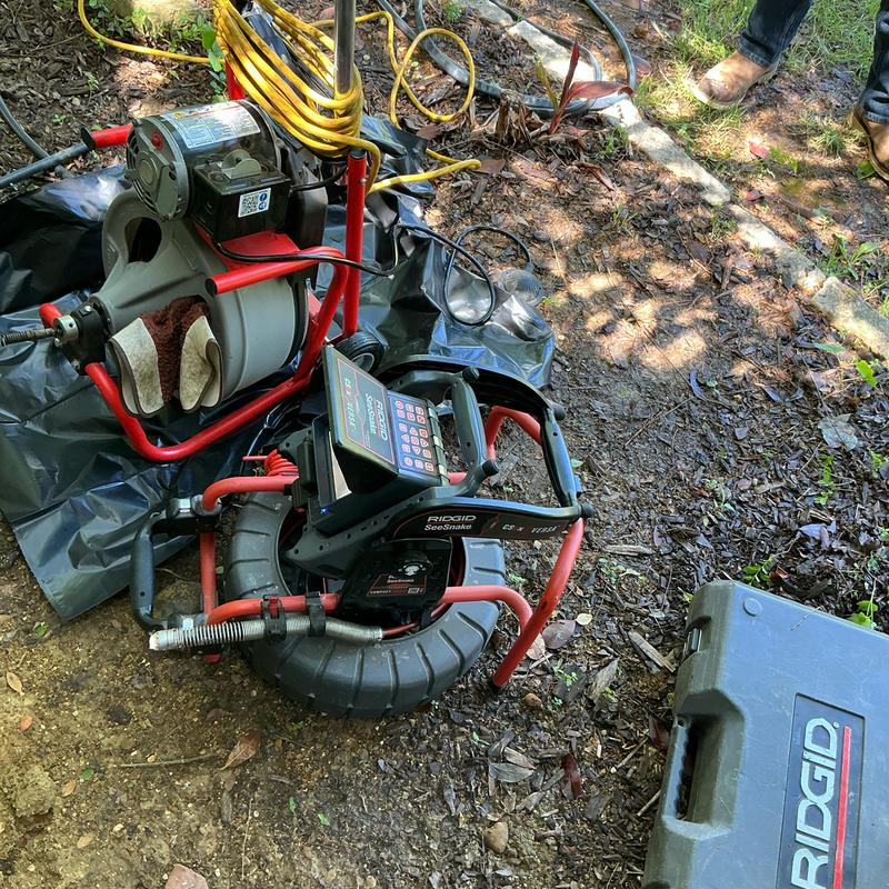 Sewer line inspection camera and cable machine setup outdoors