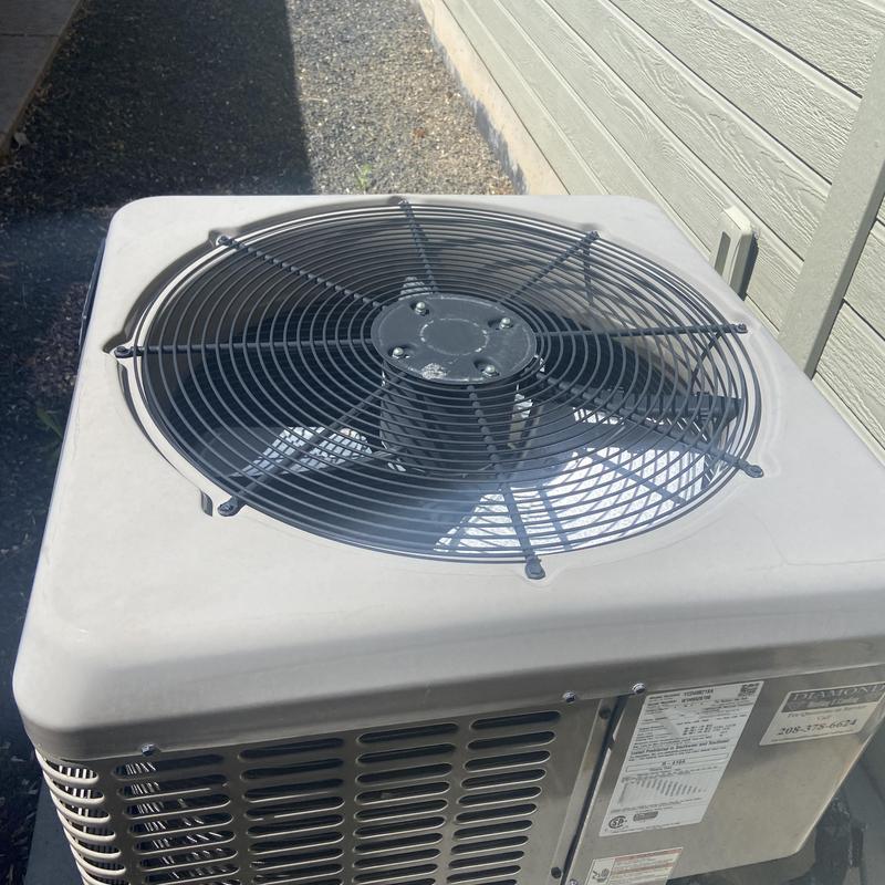 Outdoor HVAC condenser unit with fan grille