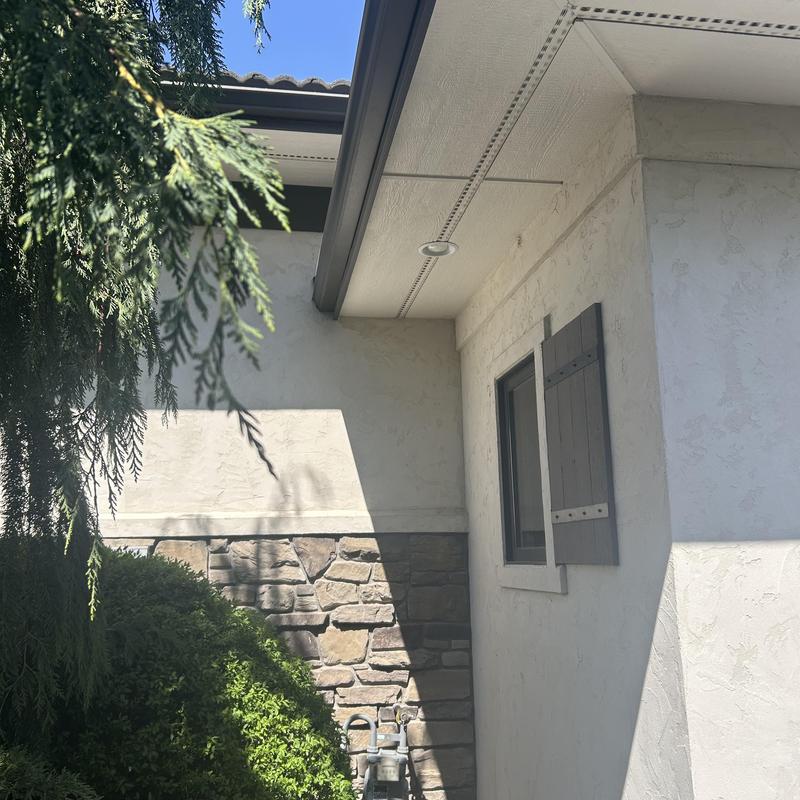 Perimeter Christmas light track on tile roof edge