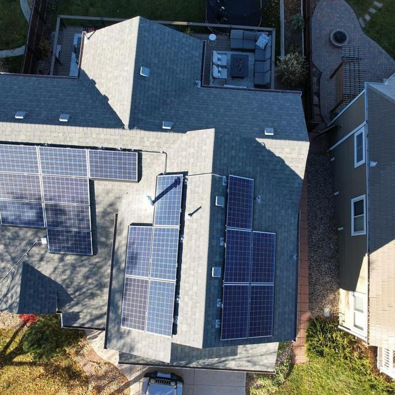 Solar panel installation on residential gray shingle roof
