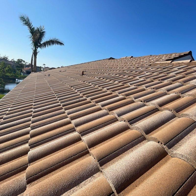 Concrete tile roof with damaged and misaligned tiles