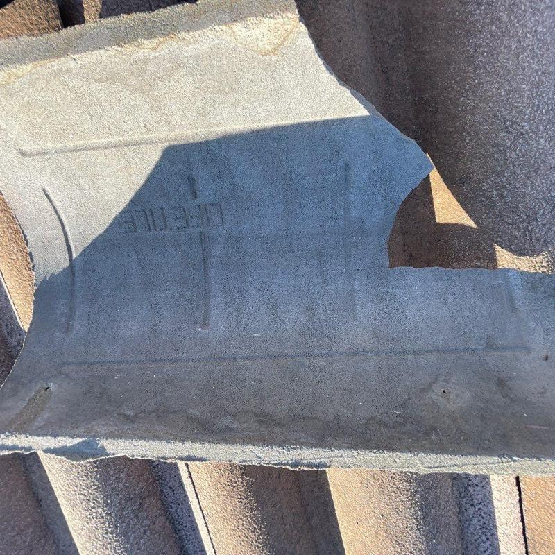 Concrete roof tile with broken edge damage