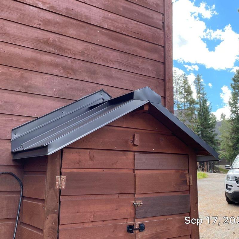 Metal shed roof flashing installation on wooden structure