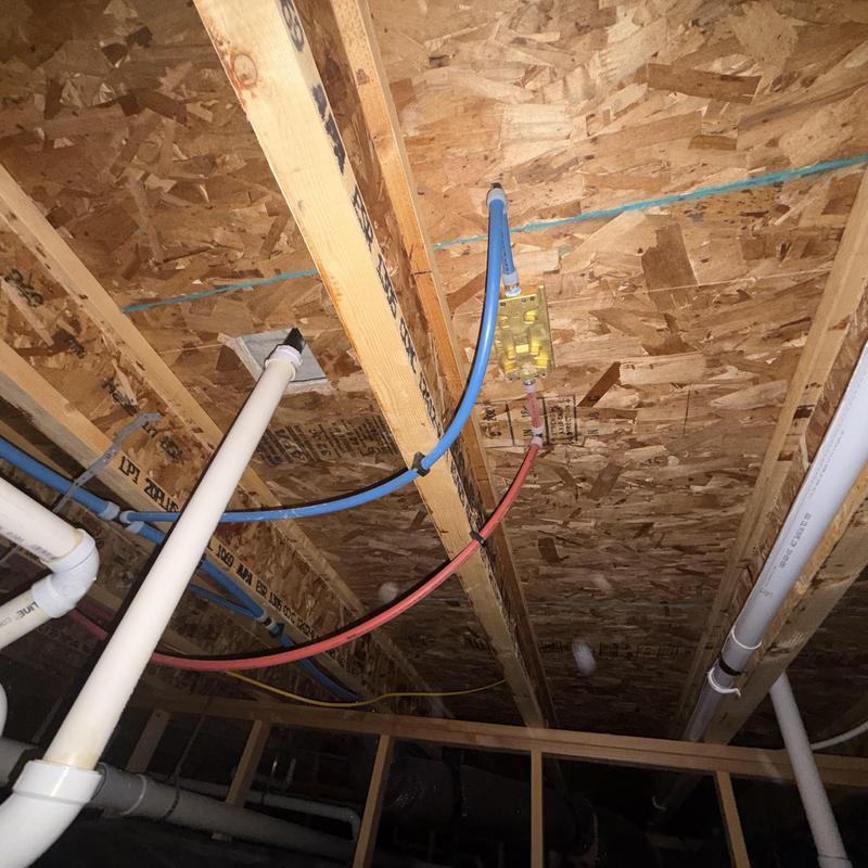 Plumbing pipes and vapor barrier in crawl space