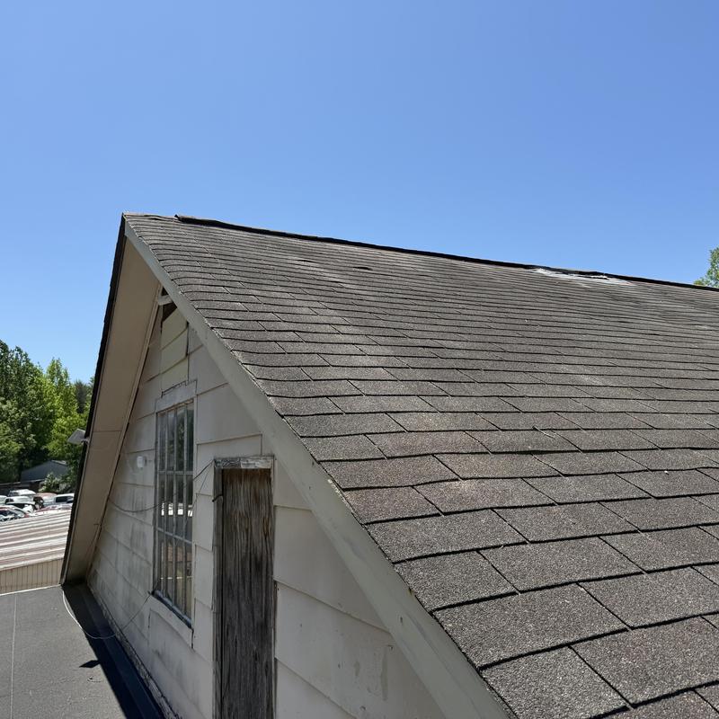 Asphalt shingle roof showing significant wear and damage