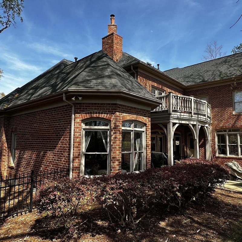 Painted gutters and new gutter guards on brick home