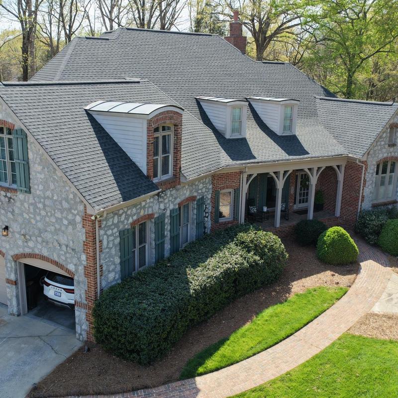 Gutter system and new gutter guards on stone home
