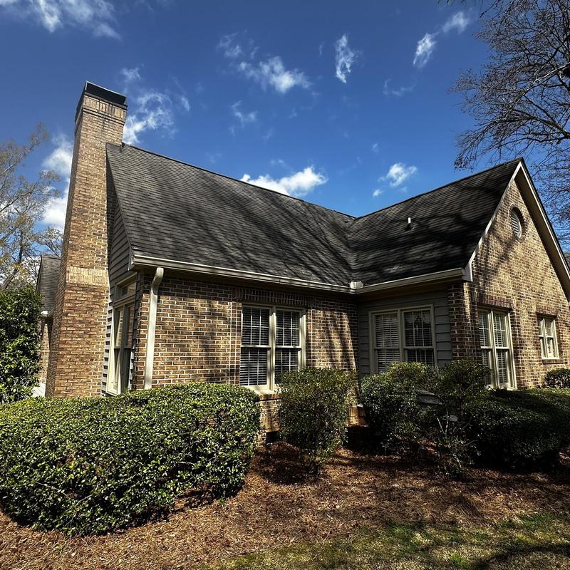 Asphalt shingle roof inspection on brick house