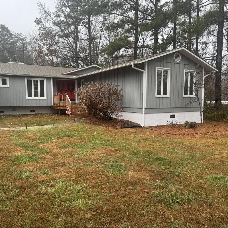 Asphalt shingle roof with minor damage and siding